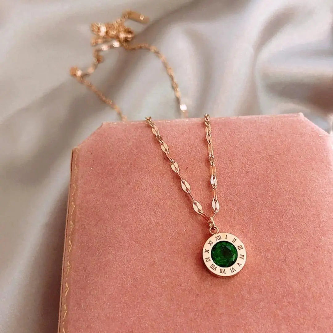 Gold Time necklace with emerald