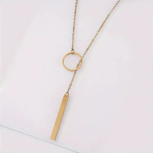 Ethnic-inspired necklace with circle and bar-shaped pendants made of metal alloy.