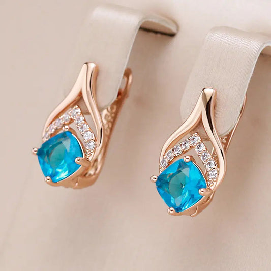 Elegant gold-plated earrings with blue crystals